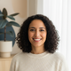 Portrait of a smiling woman in her late 30s, with a happy, trustworthy expression.